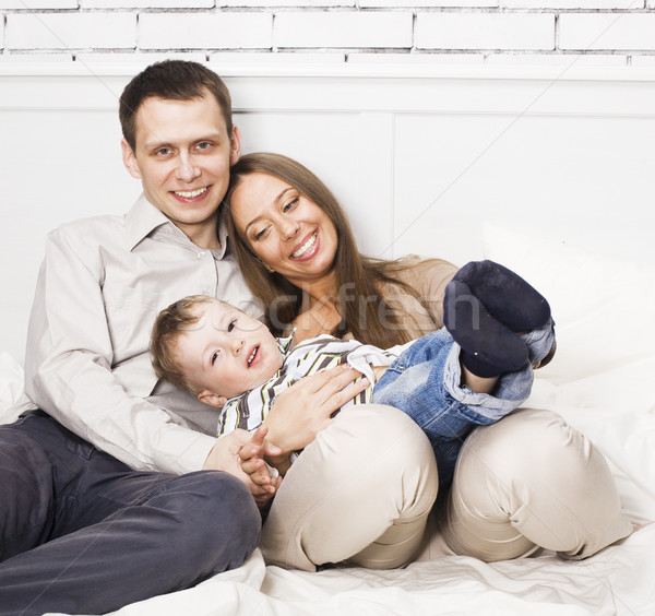 Fiatal boldog modern család mosolyog együtt Stock fotó © iordani