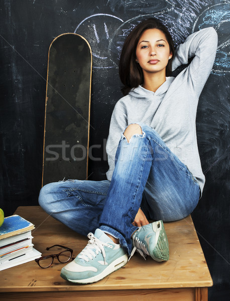 young cute teenage girl in classroom at blackboard seating on ta Stock photo © iordani