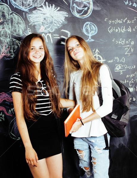 back to school after summer vacations, two teen real girls in classroom with blackboard painted toge Stock photo © iordani