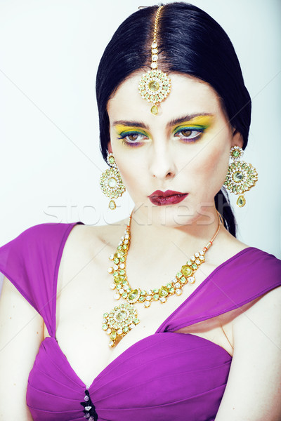 young pretty caucasian woman like indian in ethnic jewelry close up on white, bridal makeup Stock photo © iordani