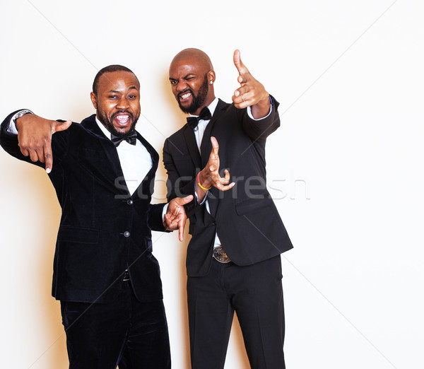 two afro-american businessmen in black suits emotional posing, gesturing, smiling. wearing bow-ties  Stock photo © iordani