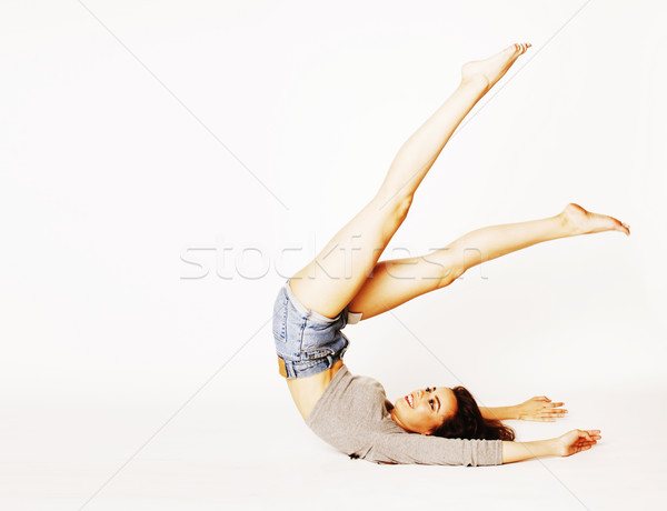 young pretty brunette woman head over heels on white isolated Stock photo © iordani