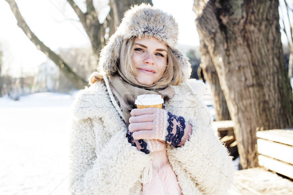 young pretty teenage hipster girl outdoor in winter snow park having fun drinking coffee, warming up Stock photo © iordani