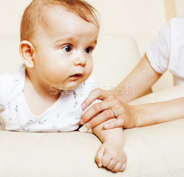 Stock photo: little cute toddler baby boy playing on chair, mother insures holding hand, lifestyle people concept