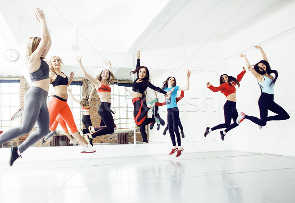 Women doing sport in gym, jumping, healthcare lifestyle people concept, modern loft studio  Stock photo © iordani