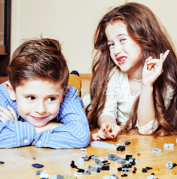 funny cute children playing lego at home, boys and girl smiling, first education role lifestyle clos Stock photo © iordani