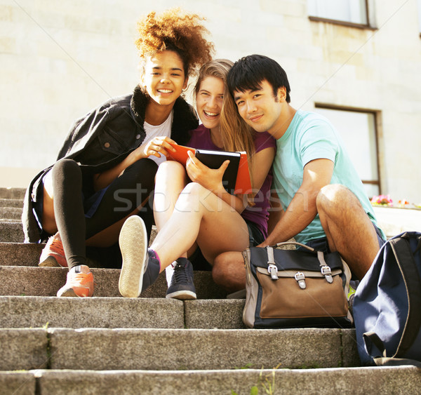 cute group teenages at the building of university Stock photo © iordani