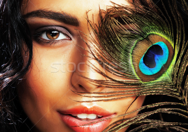 young sensitive brunette woman with peacock feather eyes close u Stock photo © iordani