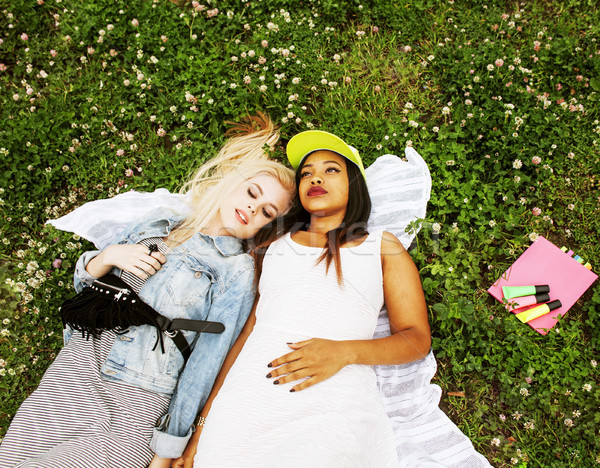 two young pretty teenager girls best friends laying on grass mak Stock photo © iordani