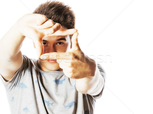 young pretty man framing with fingers isolated on white Stock photo © iordani