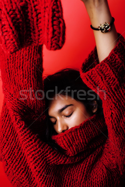 young pretty indian mulatto girl in red sweater posing emotional, fashion hipster teenage, lifestyle Stock photo © iordani