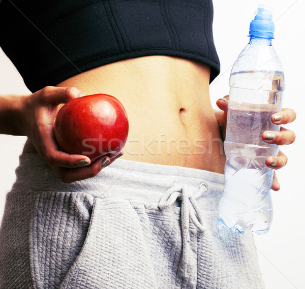 woman measuring waist with red apple and water, african tann iso Stock photo © iordani
