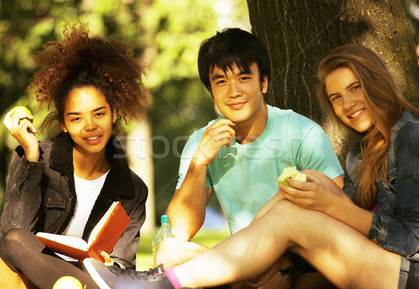 cute group of teenages at the building of university with books huggings Stock photo © iordani