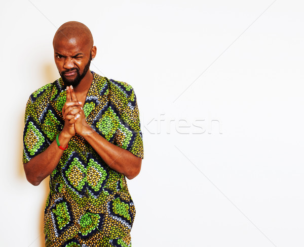portrait of young handsome african man wearing bright green national costume smiling gesturing, ente Stock photo © iordani