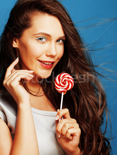 Stock photo: young pretty adorable woman with candy close up like doll