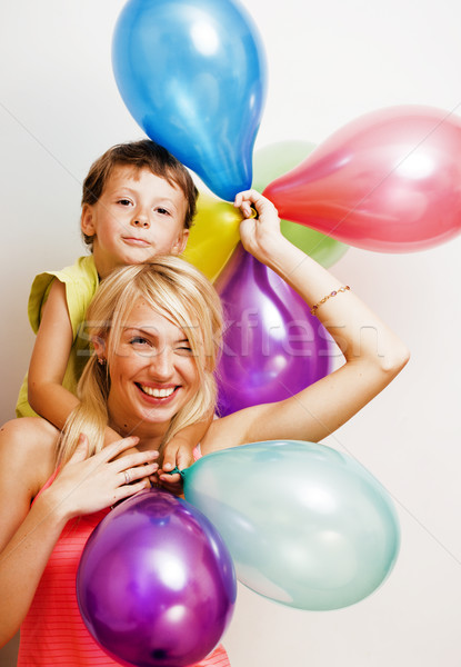 pretty family with color balloons on white background, blond woman with little boy at birthday Stock photo © iordani