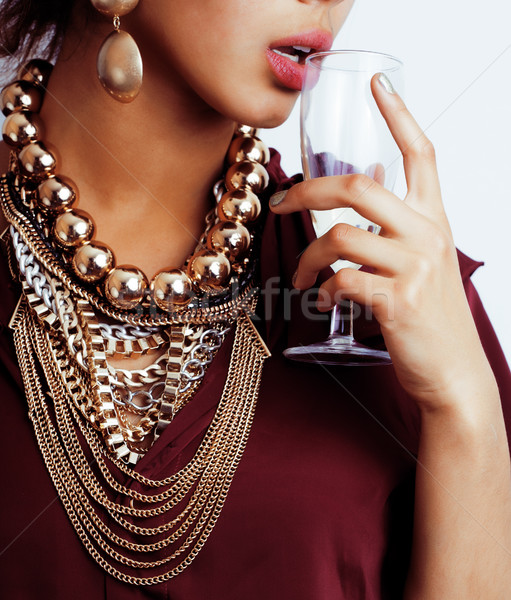young african-american woman drinking champagne, holding glass, wearing lot of golden jewelry  Stock photo © iordani