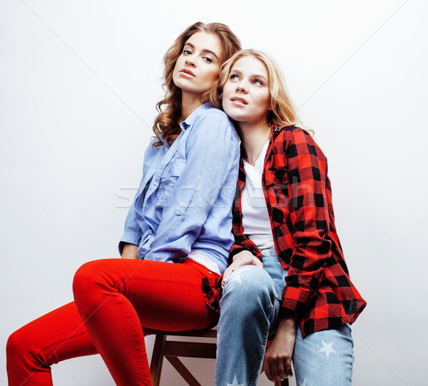 two pretty blond woman having fun together on white background, mature mother and young teenage daug Stock photo © iordani