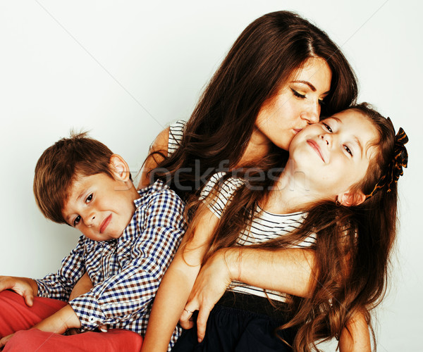 young mother with two children on white background isolated, happy smiling family, lifestyle people  Stock photo © iordani