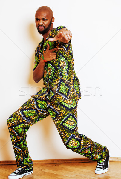 portrait of young handsome african man wearing bright green nati Stock photo © iordani