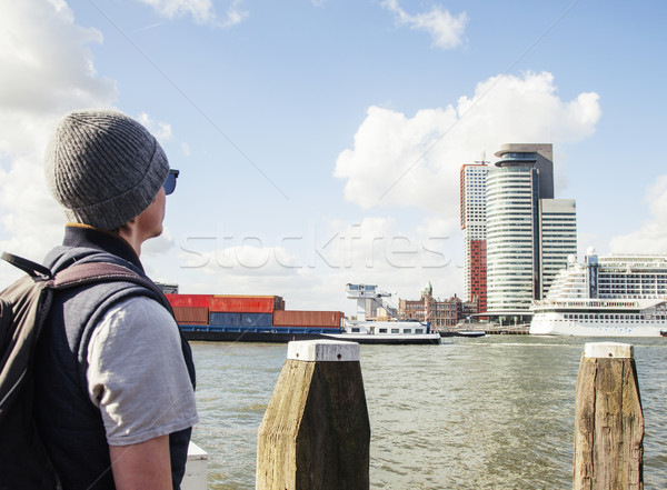 Young modern guy in hat and sunglasses, tourist with backpack lo Stock photo © iordani