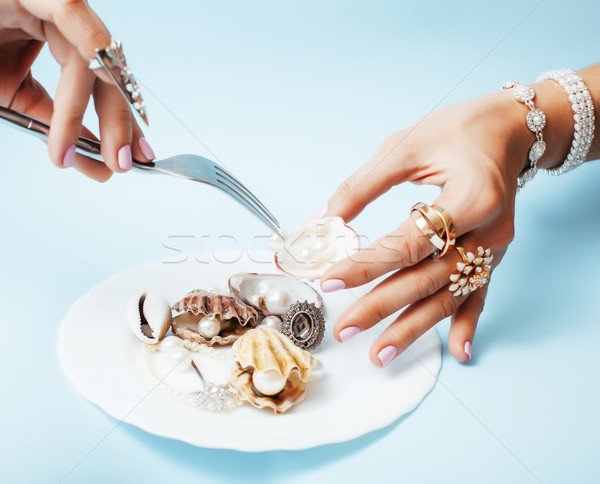 beautiful woman hands with pink manicure holding plate with pearls and sea shells, luxury jewelry co Stock photo © iordani