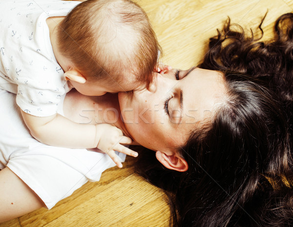 young brunette happy mother holding toddler baby son, breast-fee Stock photo © iordani