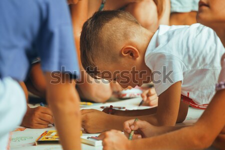 Stock photo: little cute boy with company painting on birthday party