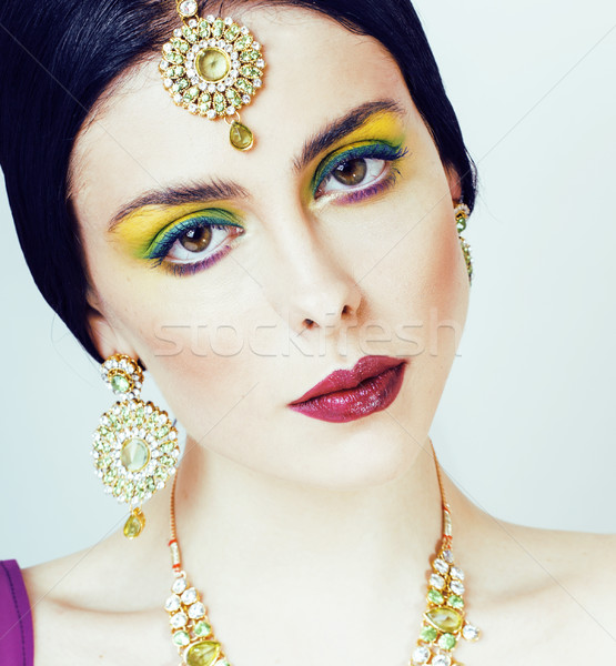 young pretty caucasian woman like indian in ethnic jewelry close up on white, bridal makeup Stock photo © iordani