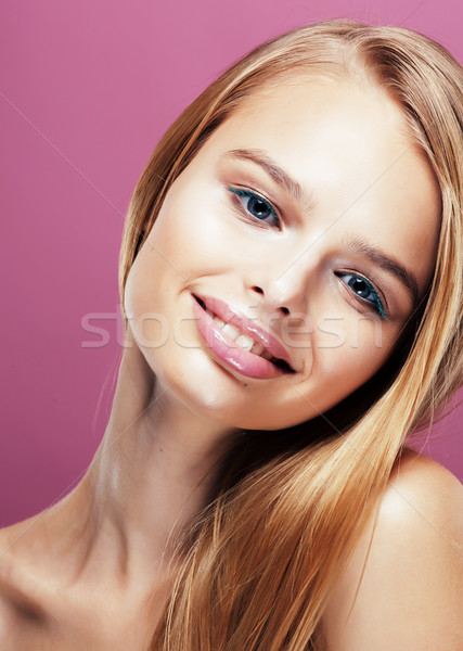 Stock photo: young pretty blonde woman with hairstyle close up and makeup on pink background