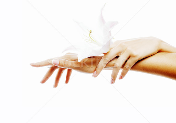 Stock photo: beauty delicate hands with manicure holding flower lily close up