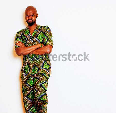 portrait of young handsome african man wearing bright green national costume smiling gesturing, ente Stock photo © iordani