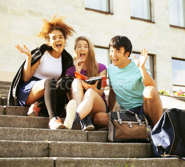 cute group of teenages at the building of university with books  Stock photo © iordani