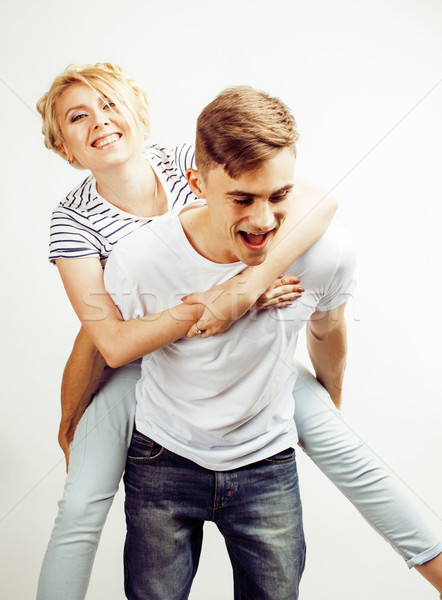 Stock photo: young pretty teenage couple, hipster guy with his girlfriend happy smiling and hugging isolated on w