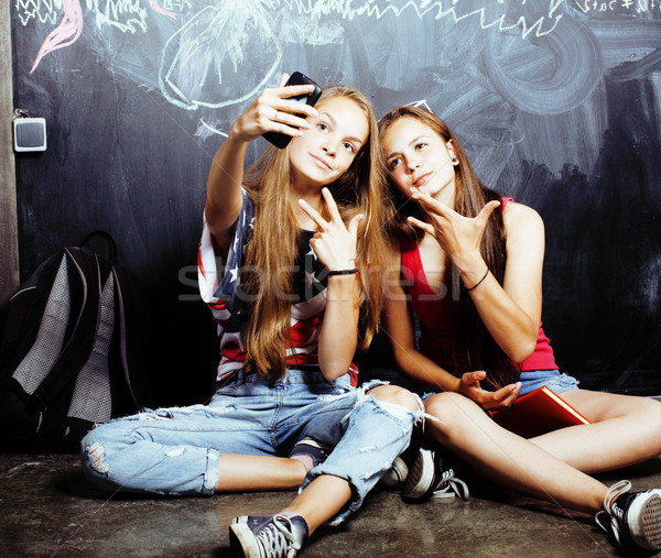 back to school after summer vacations, two teen real girls in classroom with blackboard painted toge Stock photo © iordani