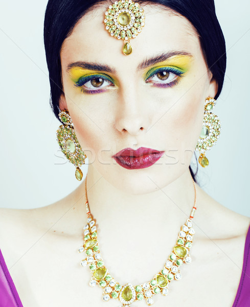 young pretty caucasian woman like indian in ethnic jewelry close up on white, bridal bright makeup Stock photo © iordani