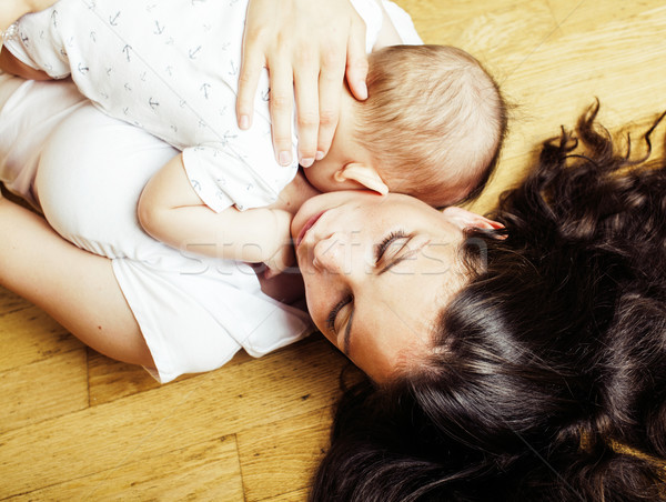 young brunette happy mother holding toddler baby son, breast-feeding concept, lifestyle modern peopl Stock photo © iordani