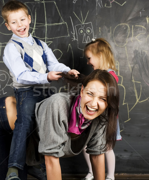teacher with crazy kid in classroom fighting, lifestyle education people concept Stock photo © iordani