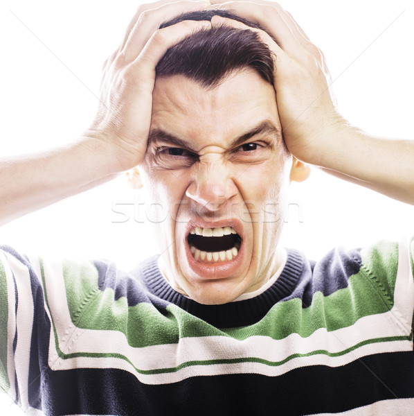 Portrait of a smart serious young man standing against white bac Stock photo © iordani