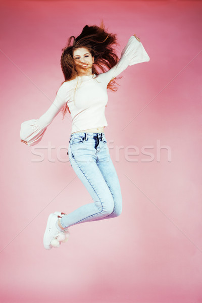 young pretty teenage redhair girl jumping cheerful isolated on pink background, lifestyle people con Stock photo © iordani