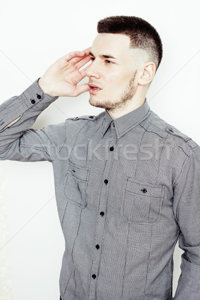 young handsome well-groomed guy posing emotional on white background, lifestyle people concept  Stock photo © iordani