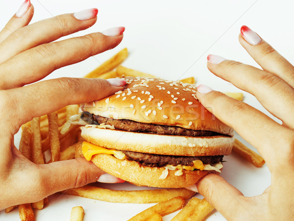 woman hands with manicure holding hamburger and french fries iso Stock photo © iordani