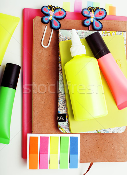 business, education and technology concept - close up of notebook, paper stickers, glasses, pencil d Stock photo © iordani