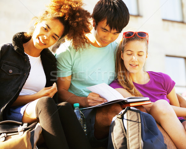 cute group of teenages at the building of university with books  Stock photo © iordani