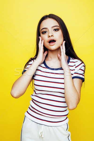 young pretty teenage woman emotional posing on yellow background, fashion lifestyle people concept Stock photo © iordani
