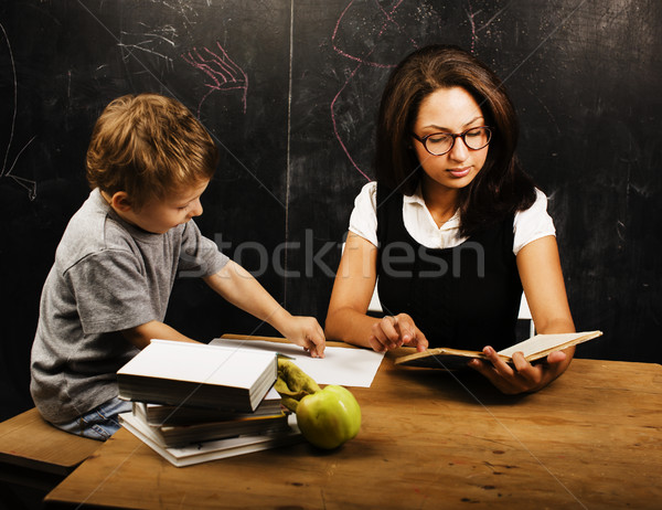 little cute boy with young teacher in classroom studying at blac Stock photo © iordani