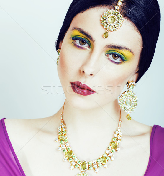 young pretty caucasian woman like indian in ethnic jewelry close up on white, bridal bright makeup f Stock photo © iordani