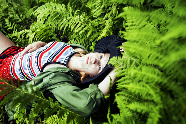 Pretty young blond girl hipster in hat among fern, vacation in g Stock photo © iordani