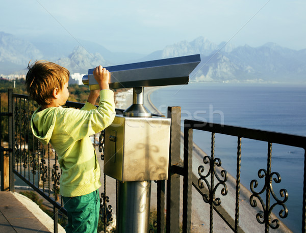 little cute boy looking through telescope at sea viewpoint in Ataturk park Stock photo © iordani