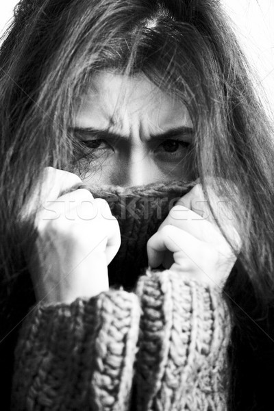 Stock photo: young brunette gloomy woman in sweater all over her face, messed hair